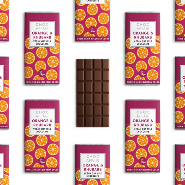 Multiple orange & rhubarb oat m!lk chocolate bars arranged on white background