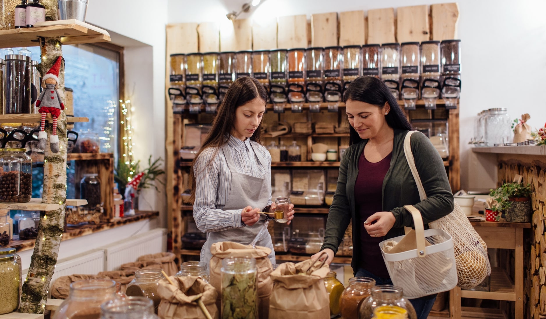 A women working at a shop helping a woman customer