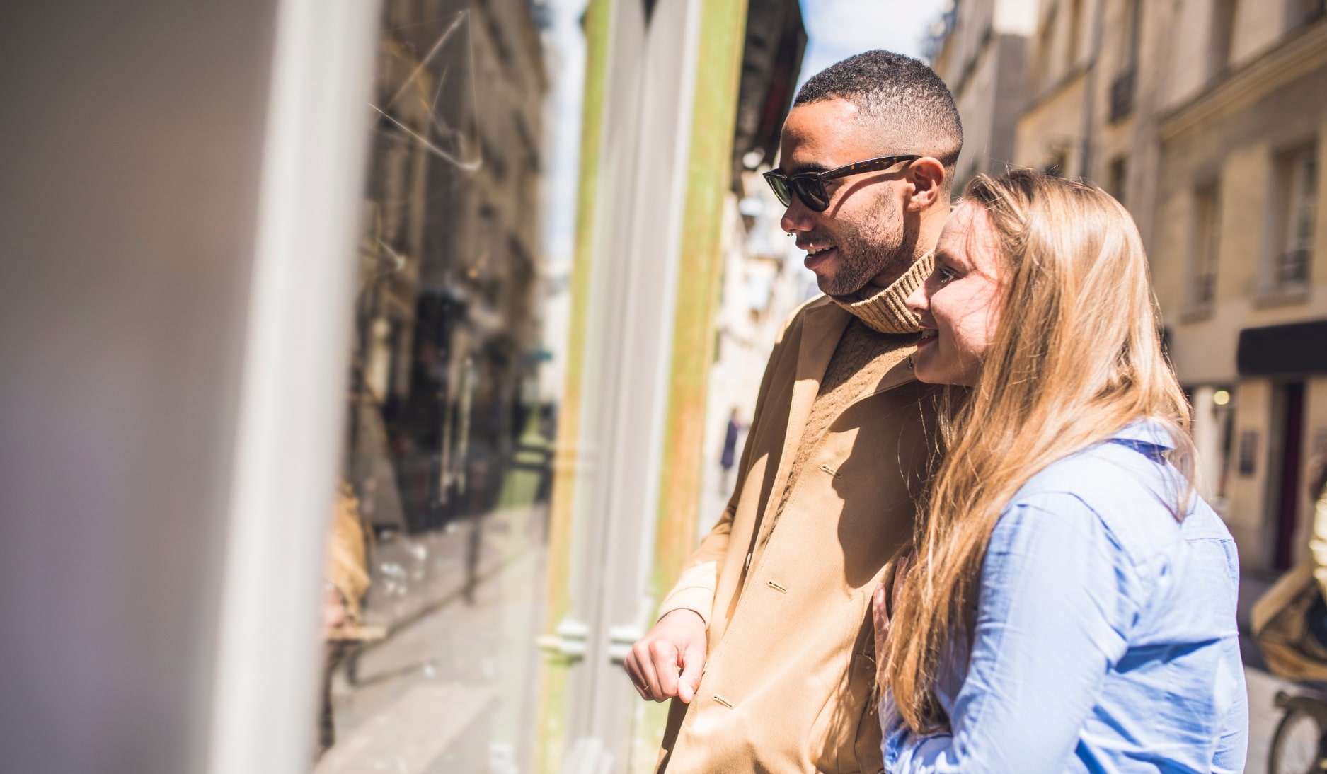 A man and a women looking into a shop window