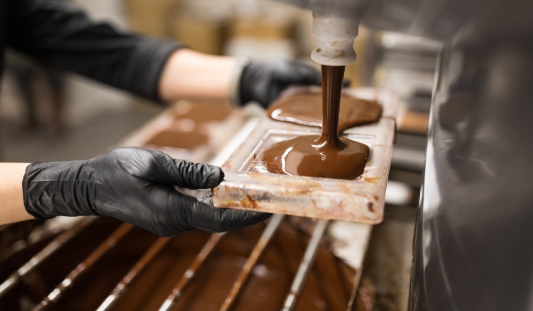 Pouring melted chocolate into a mould