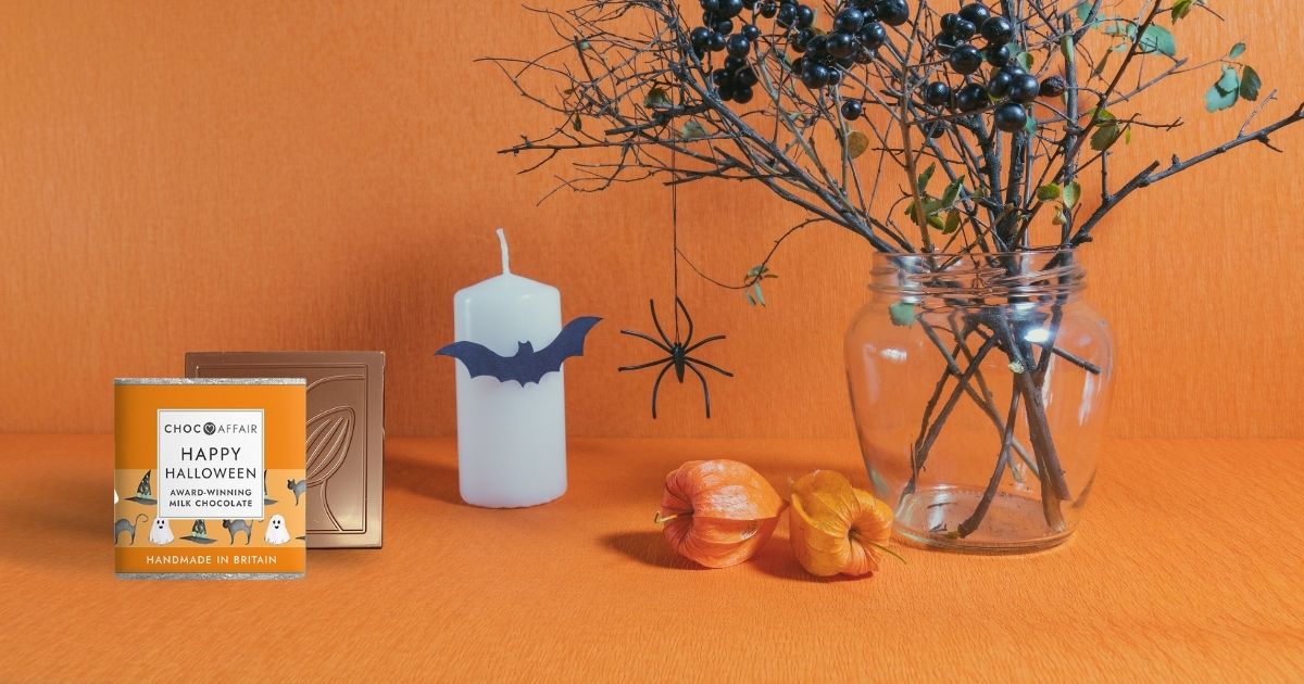 A Halloween chocolate bar next to a Halloween candle