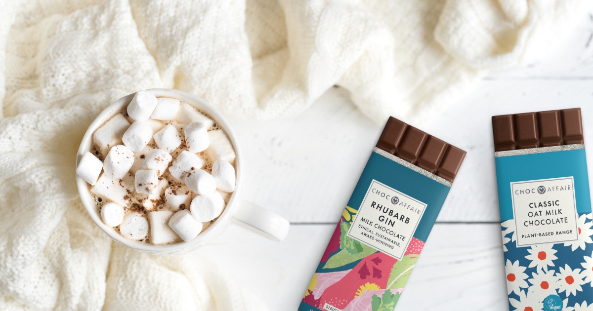 Vegan and gin favoured chocolate next to a mug of hot chocolate